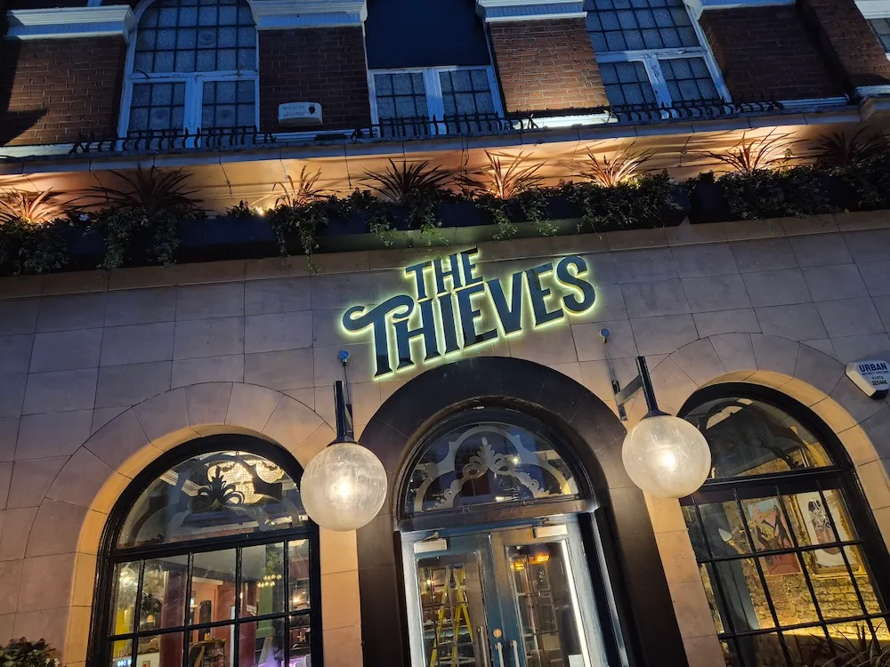 The Thieves pub exterior signage at night