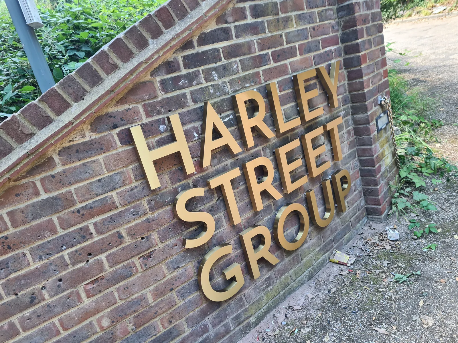 Harley Street Group gold letters on a brick wall