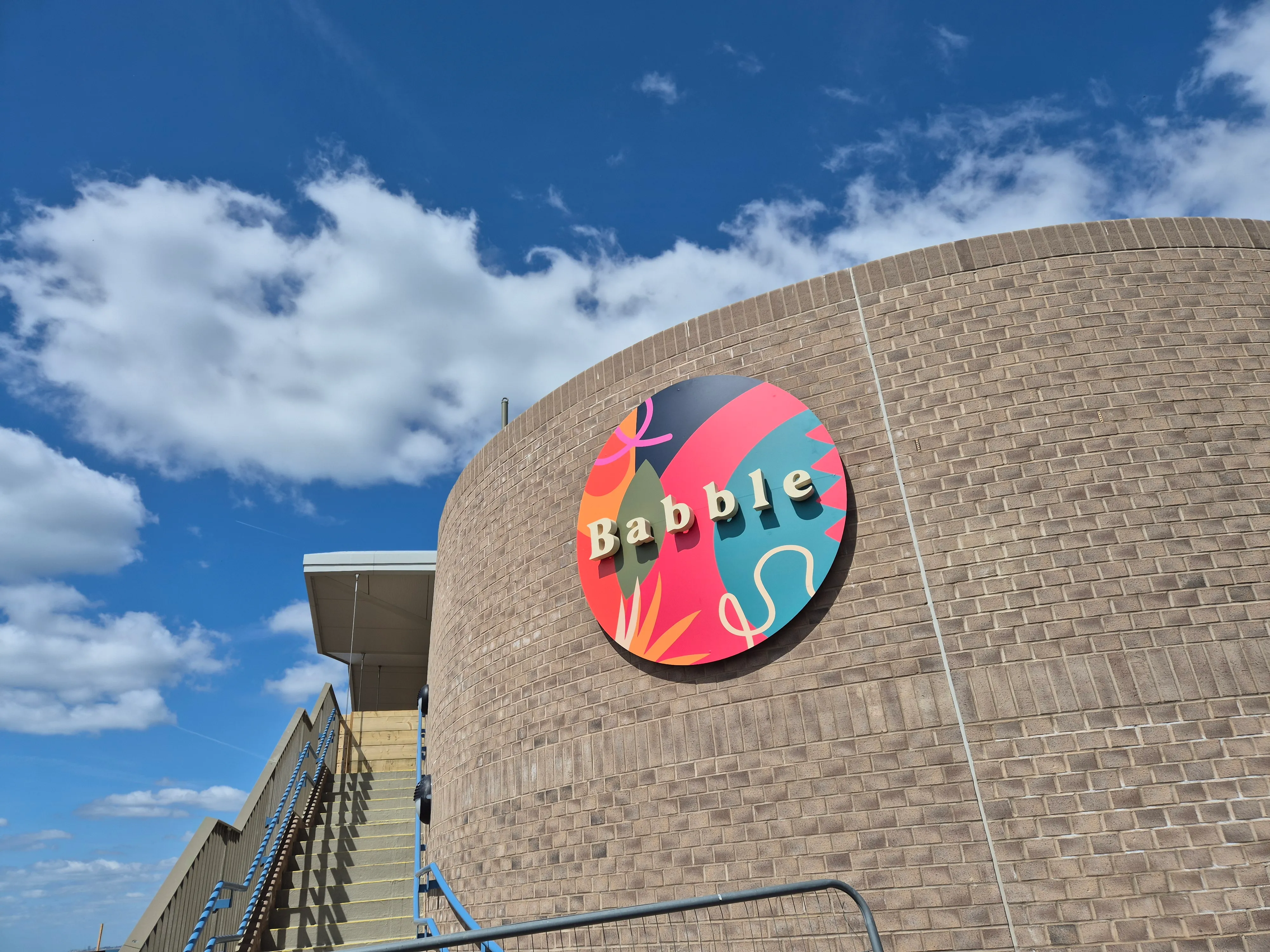 Babble sign on a curved brick building