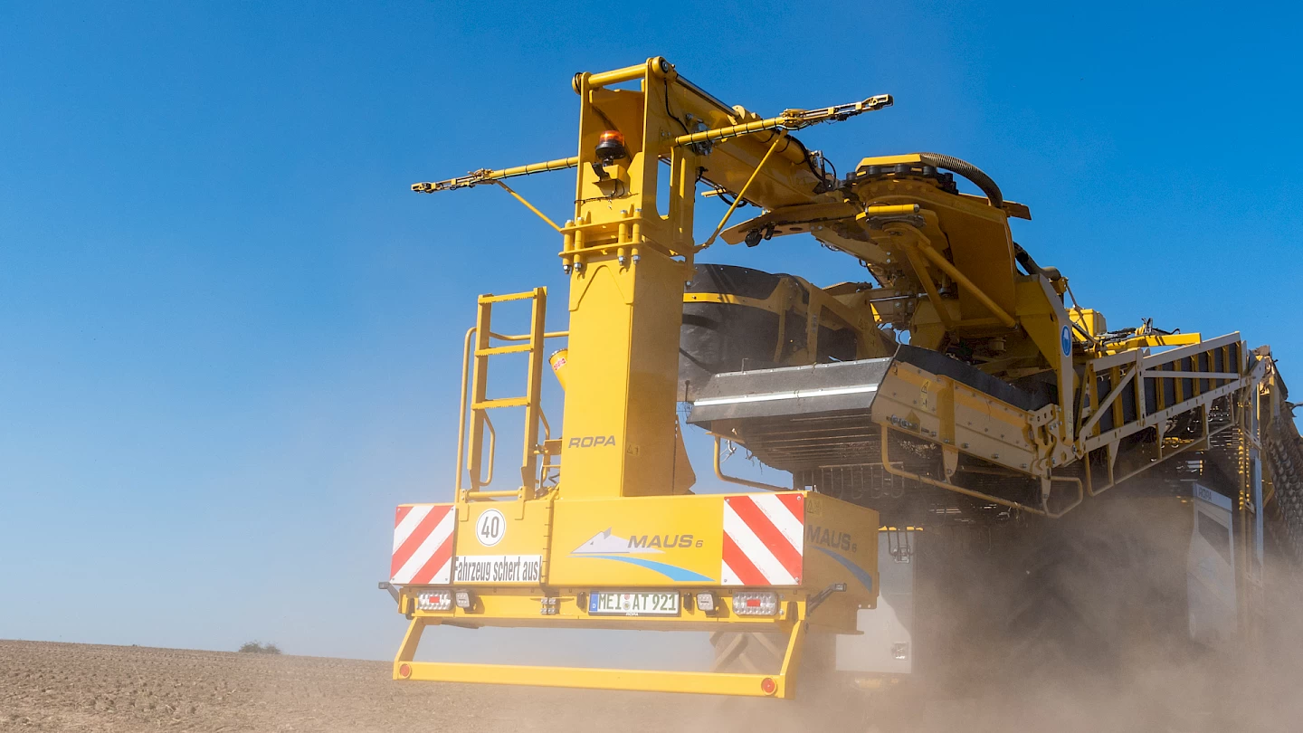 The rearview of a ROPA Maus 6 travelling down a dusty road