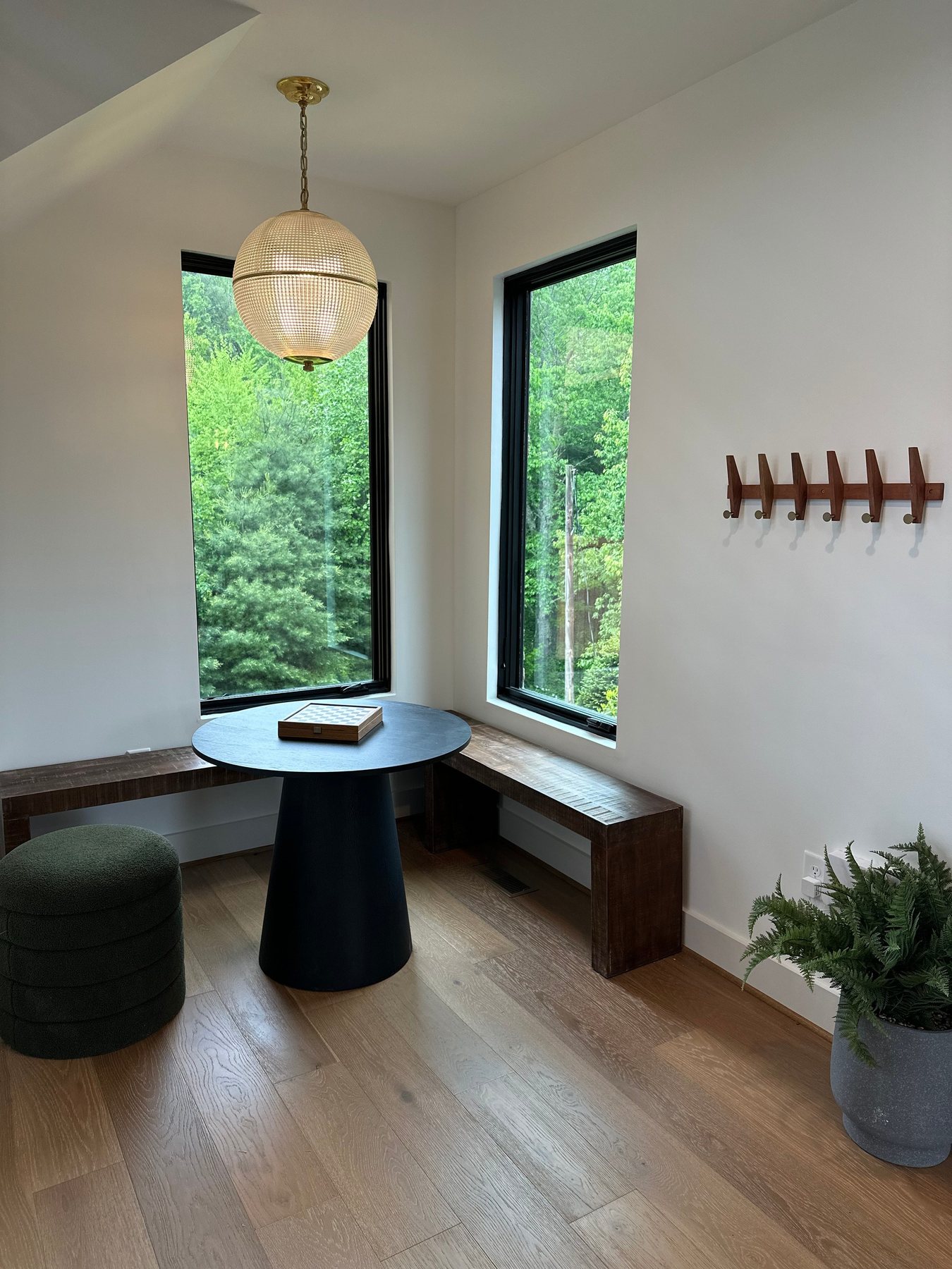 Breakfast nook with round black table and globe pendant