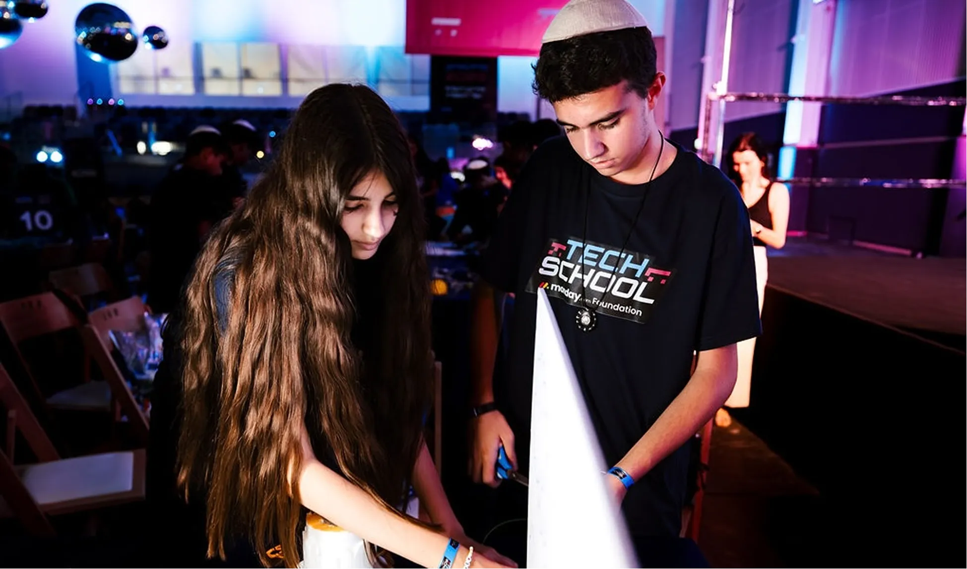 Two students working together in a project.