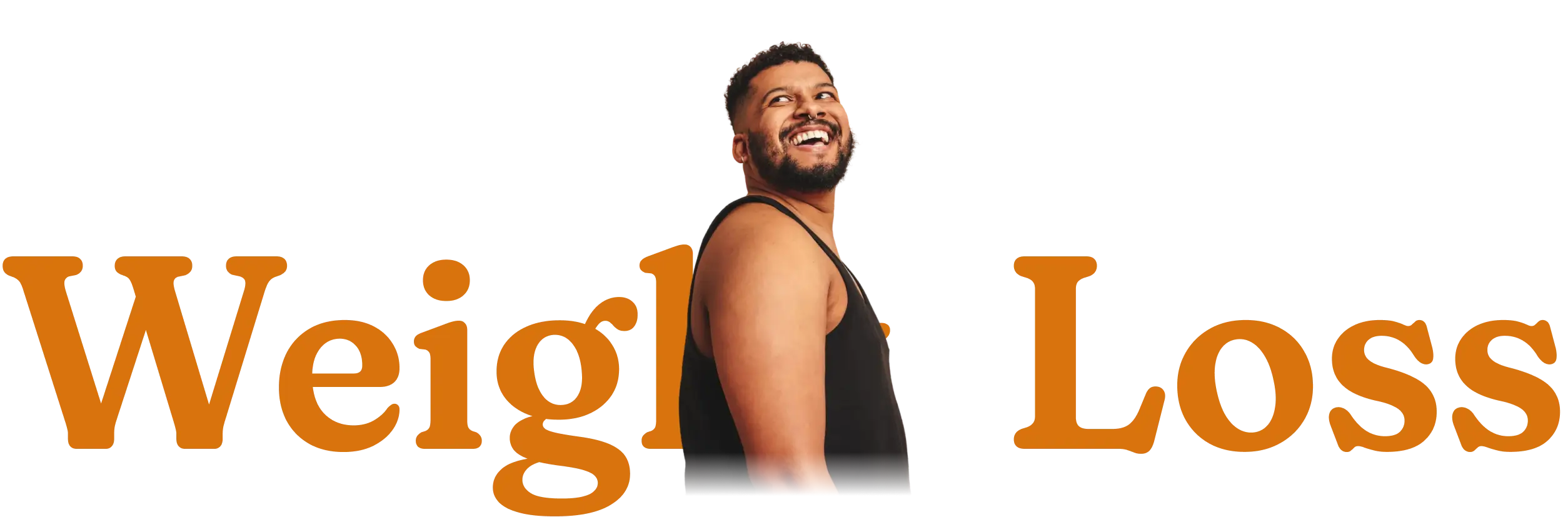 Smiling man with beard wearing a black tank top looking upward.