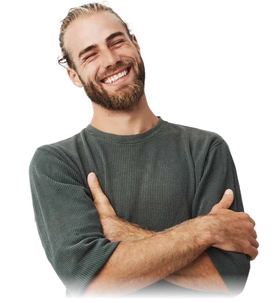 Smiling bearded man with closed eyes wearing a green long-sleeve shirt, arms crossed.