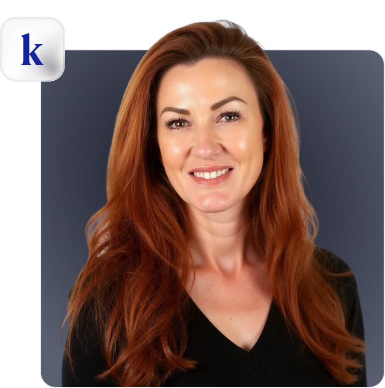 Smiling woman with long red hair wearing a black top against a dark gradient background.