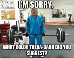 Elderly person lifting weights in gym. Humorous image about physical therapy.