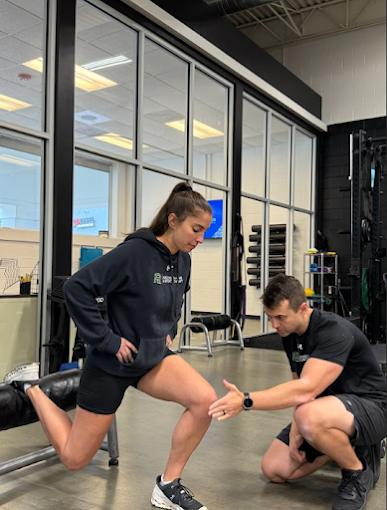 Patient working with a provider at a performance physical therapy clinic in Charlotte during biomechanical assessment