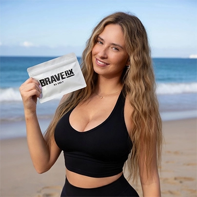A woman holding BraveRX Surge package