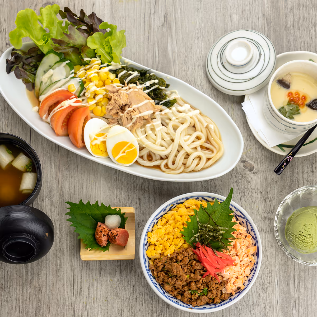 Japanese ramen bowl with noodles, egg, vegetables, and meat on wooden table.