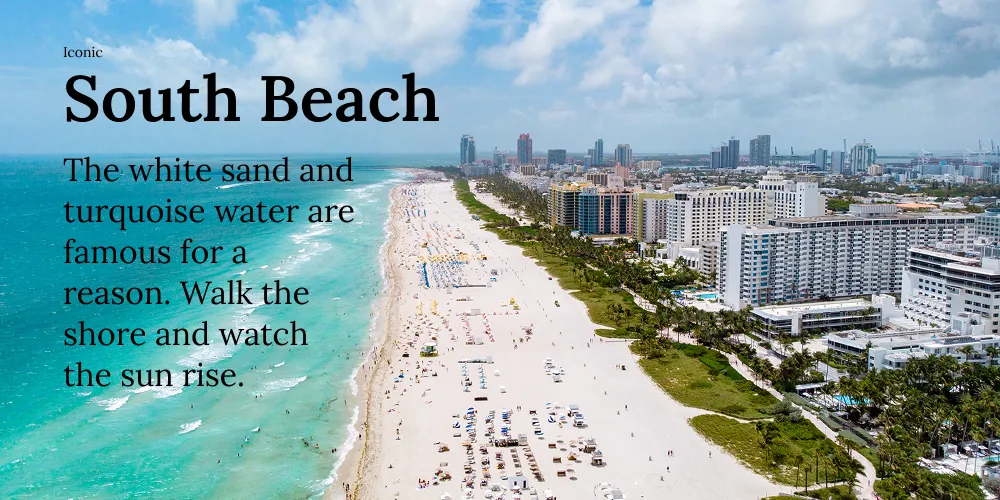 Aerial view of South Beach Miami with white sand, turquoise water, beachfront buildings, and a partly cloudy sky.