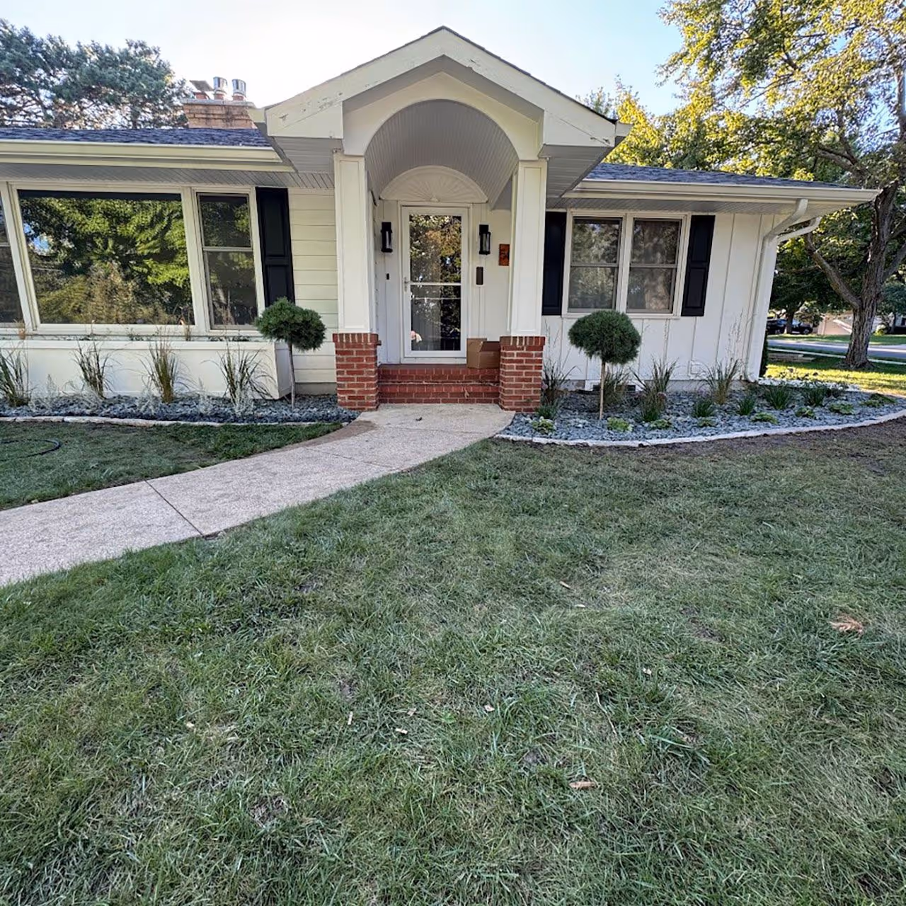 Professional landscape installation with greenery and stonework
