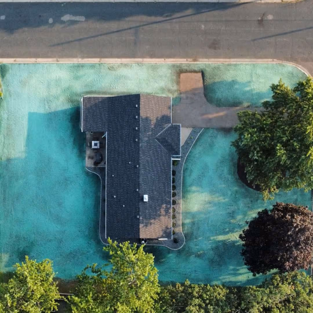 Aerial view of a home with new seeding by Sota Landscaping