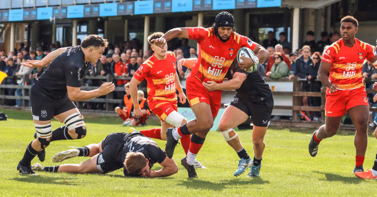 Cambridge rugby player running with a ball