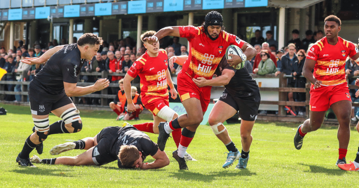 Cambridge rugby player running with a ball