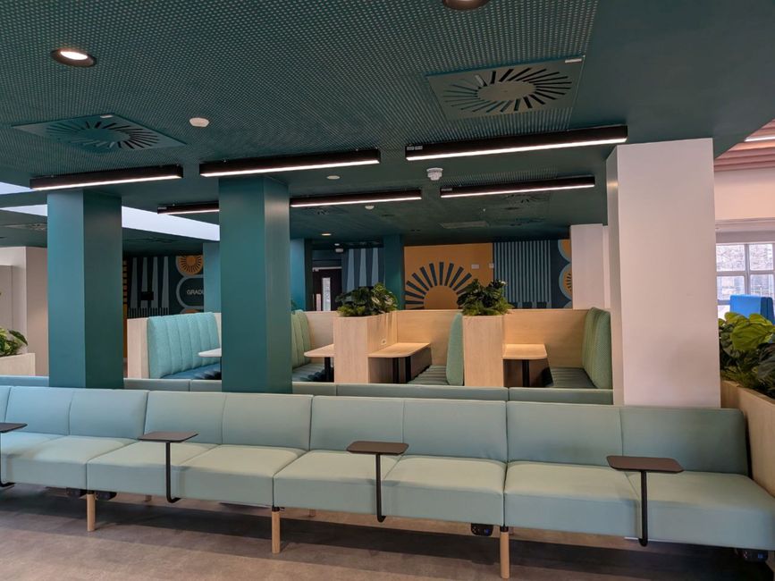 Spacious modern lounge in London with geometric accents and ergonomic seating.