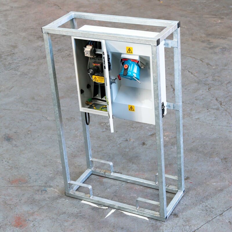 Metal frame with an open electrical control box mounted inside, featuring wires, switches, and a blue industrial sensor.