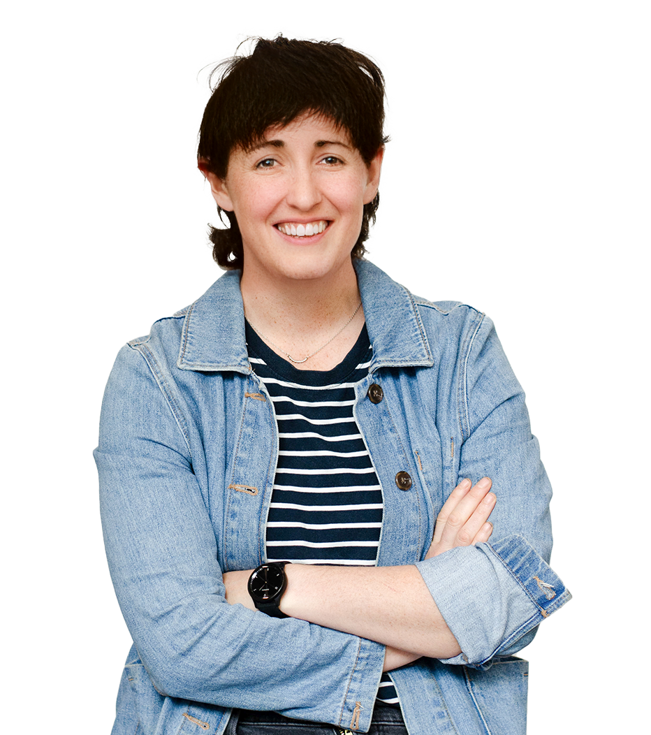 Portrait of Sandi MacKechnie with arms folded smiling at camera, wearing a striped t-shirt and denim jacket