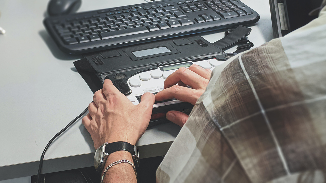 Over the shoulder view of someone using an accessible keyboard