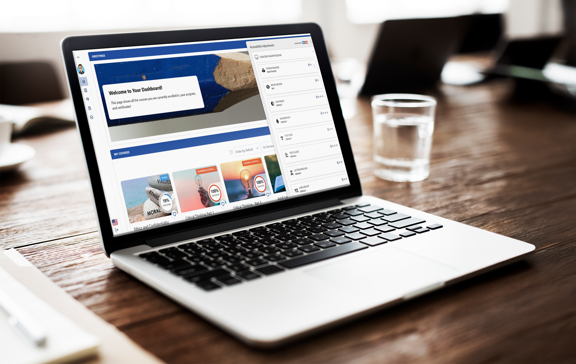 YesLMS course dashboard on a laptop screen