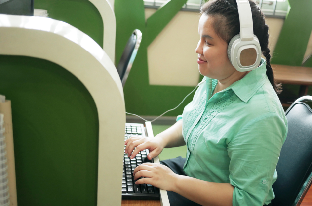 a person wearing headphones and using a computer