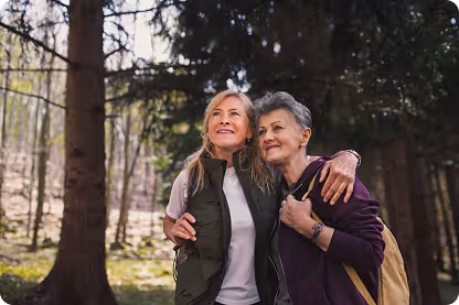 Two women, standing in a park, looking at the view.