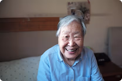 Older woman, smiling and laughing.