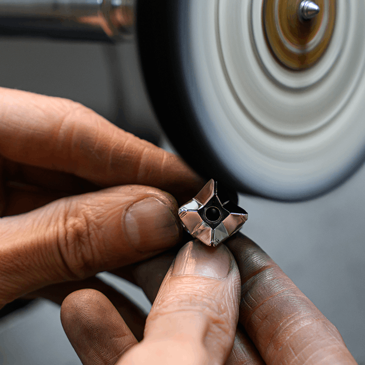 A professional picture of a Layrium Destiny Pendant getting polish in the lab