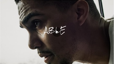 Headshot of a man actively sweating from physical exertion. The word Able appears as a title.