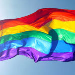 Image of rainbow colored Pride Flag blowing in the breeze