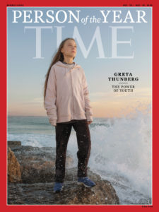 Image of a Time magazine Person of the Year cover showing a Scandinavian girl wearing black pants and a sweater standing on a beach looking down the coastline with the words, Greta Thunberg, The Power of Youth
