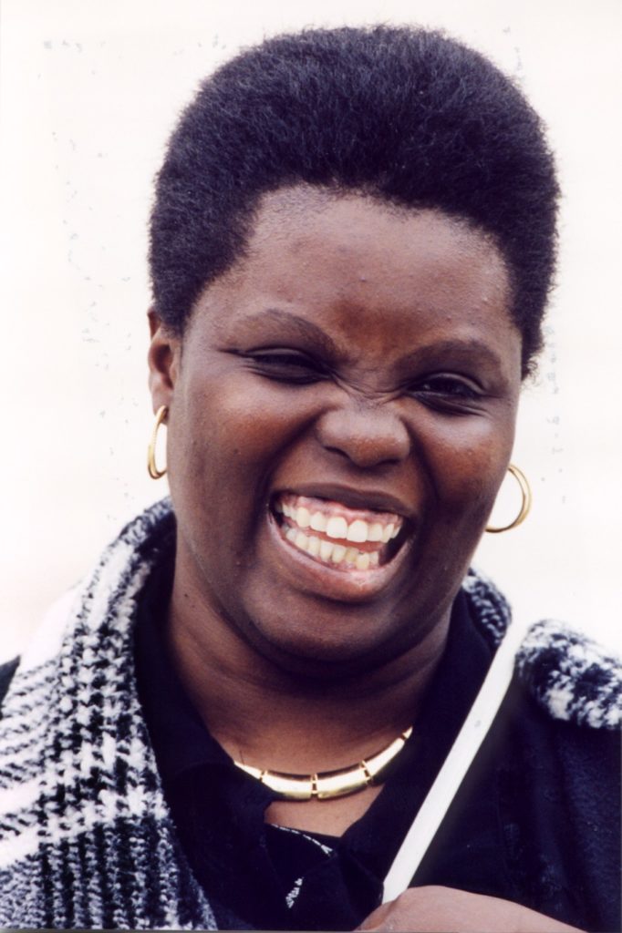 Image of smiling African-American woman wearing a tartan scarf
