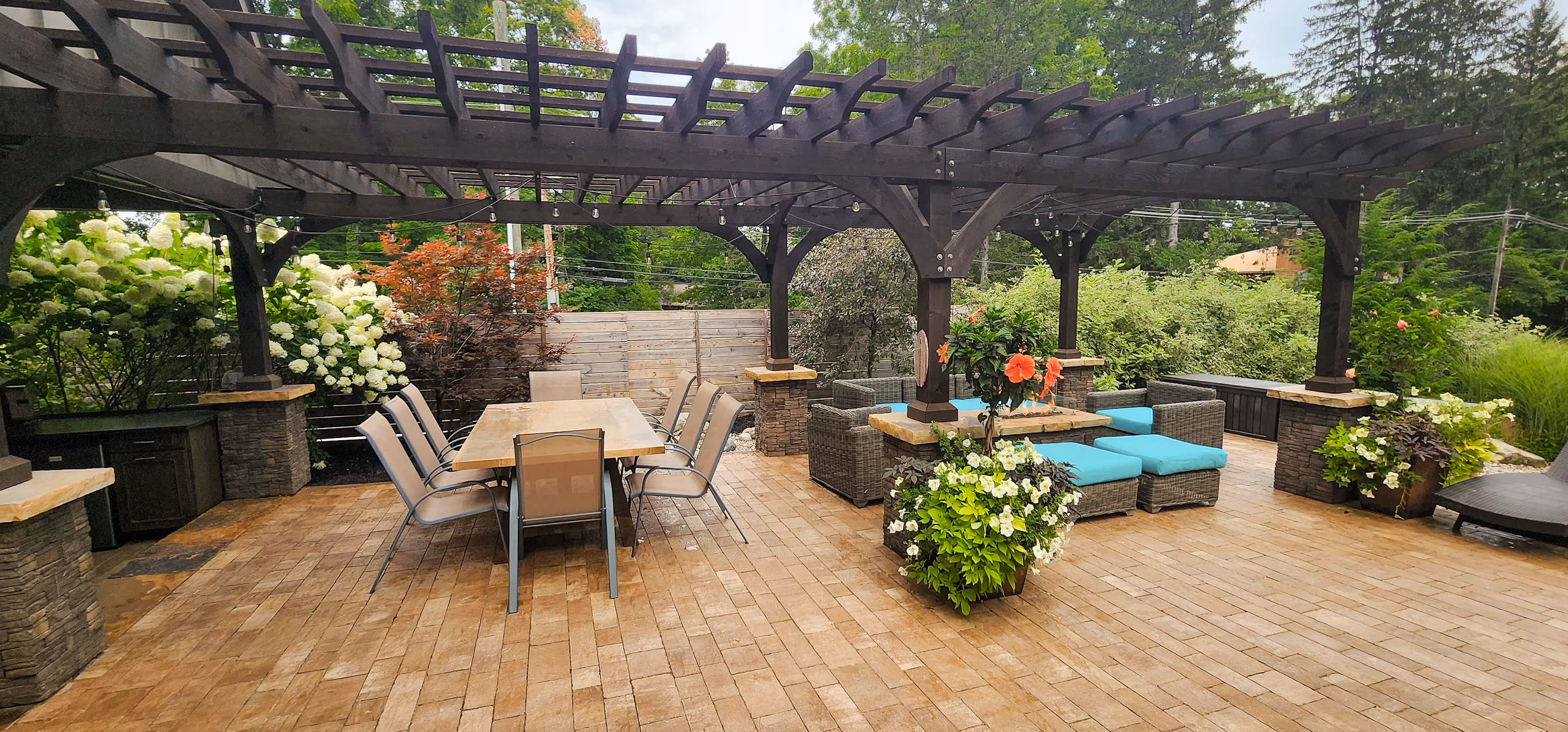 Patio with pergola, landscaping, and fire feature