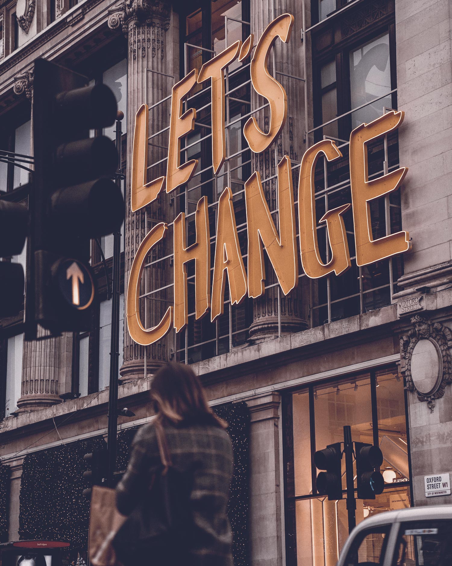 Image showing a big sign that reads 'Let's Change' on the side of a building
