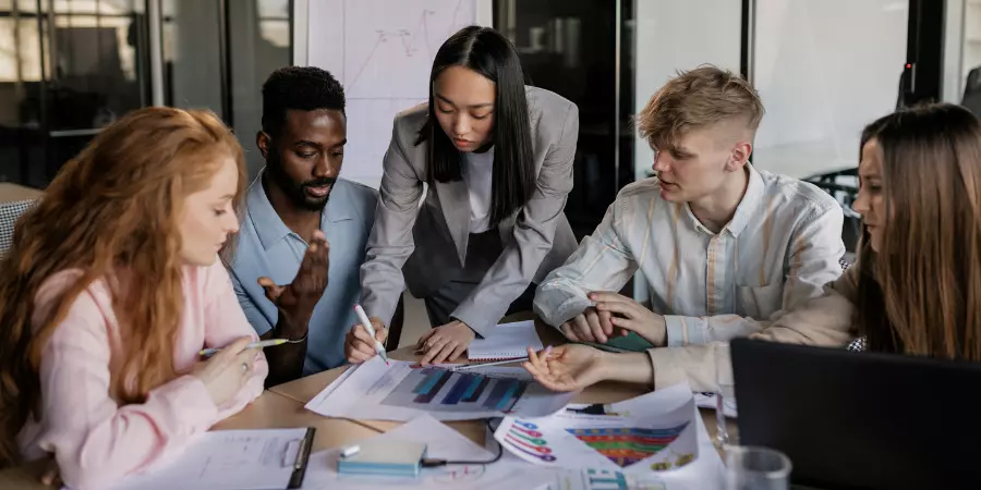 A team looking at graphs in an office