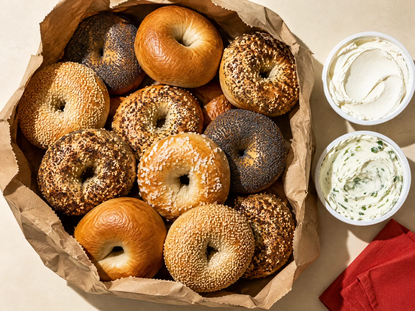 A full bag of assorted New York style bagels with plain and scallion schmears