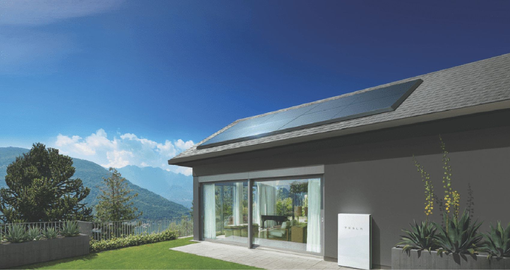 Modern house with solar panels on the roof and a Tesla Powerwall battery unit beside sliding glass doors, surrounded by plants and mountains in the background.