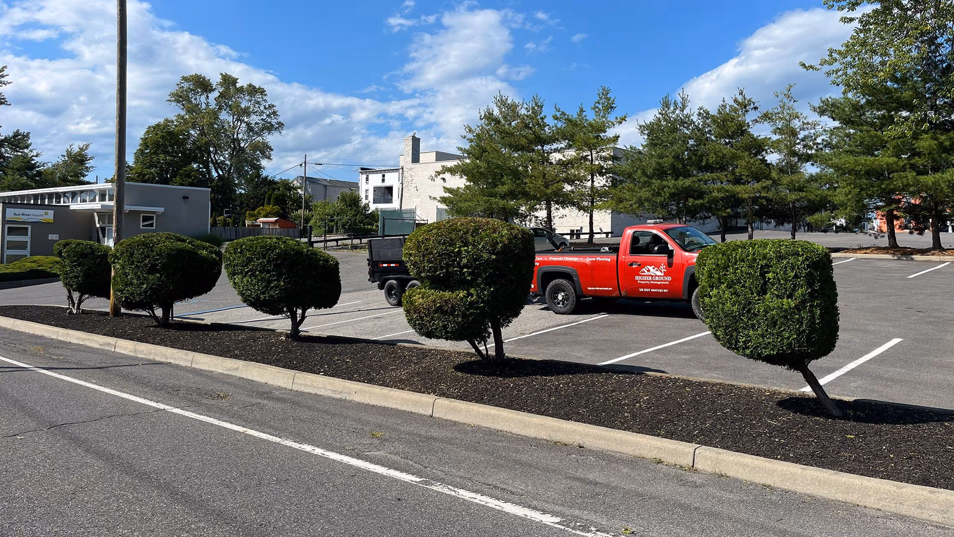 Landscaping with fresh mulch installation and clean garden bed edges by Higher Ground Property Management LLC in Red Hook NY