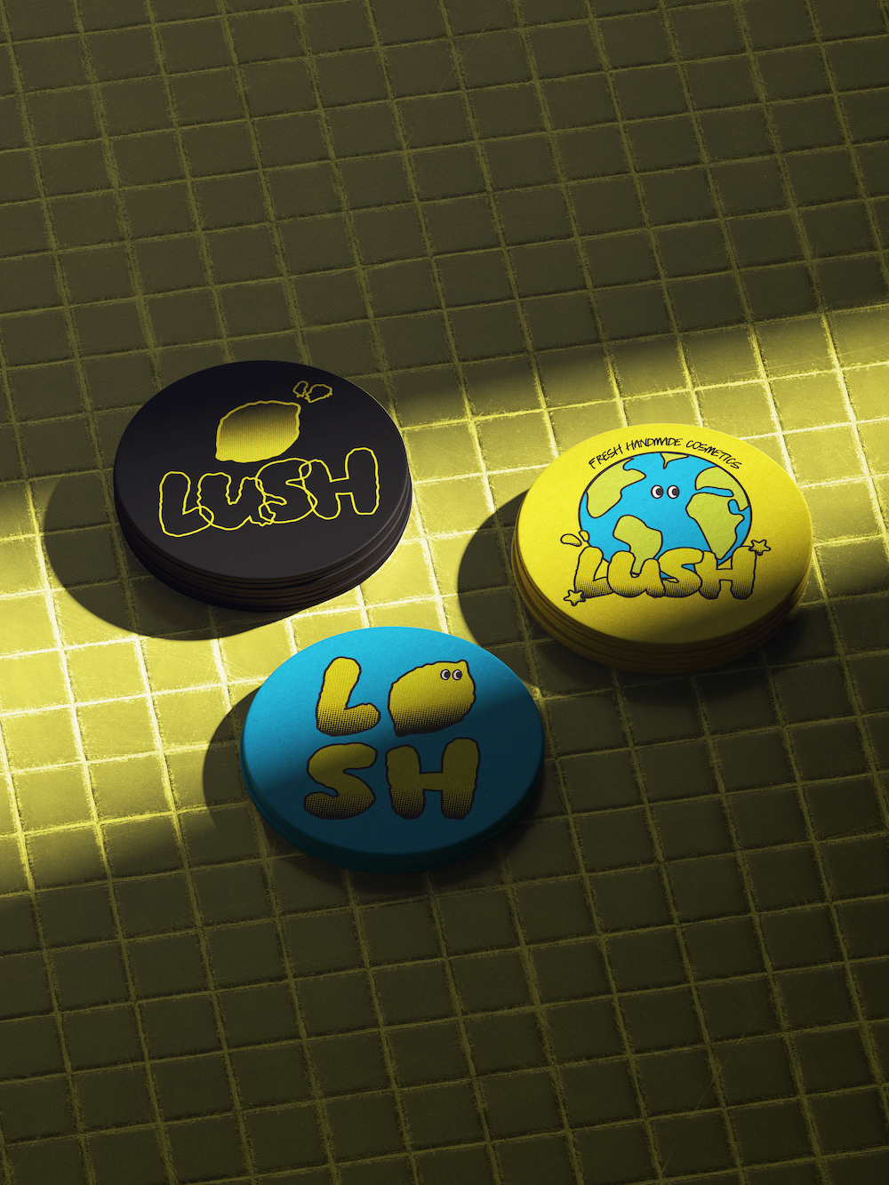 Three stacks of round cards with colorful LUSH logos on a yellow tile surface under sunlight.