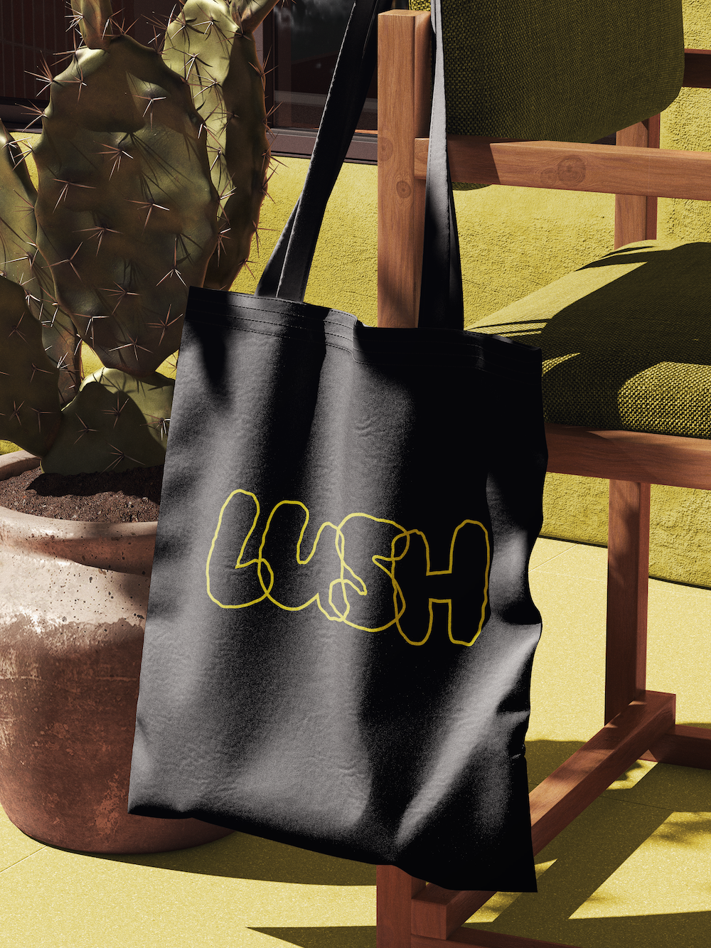 Black tote bag with yellow outlined text 'LUSH' hangs on chair.