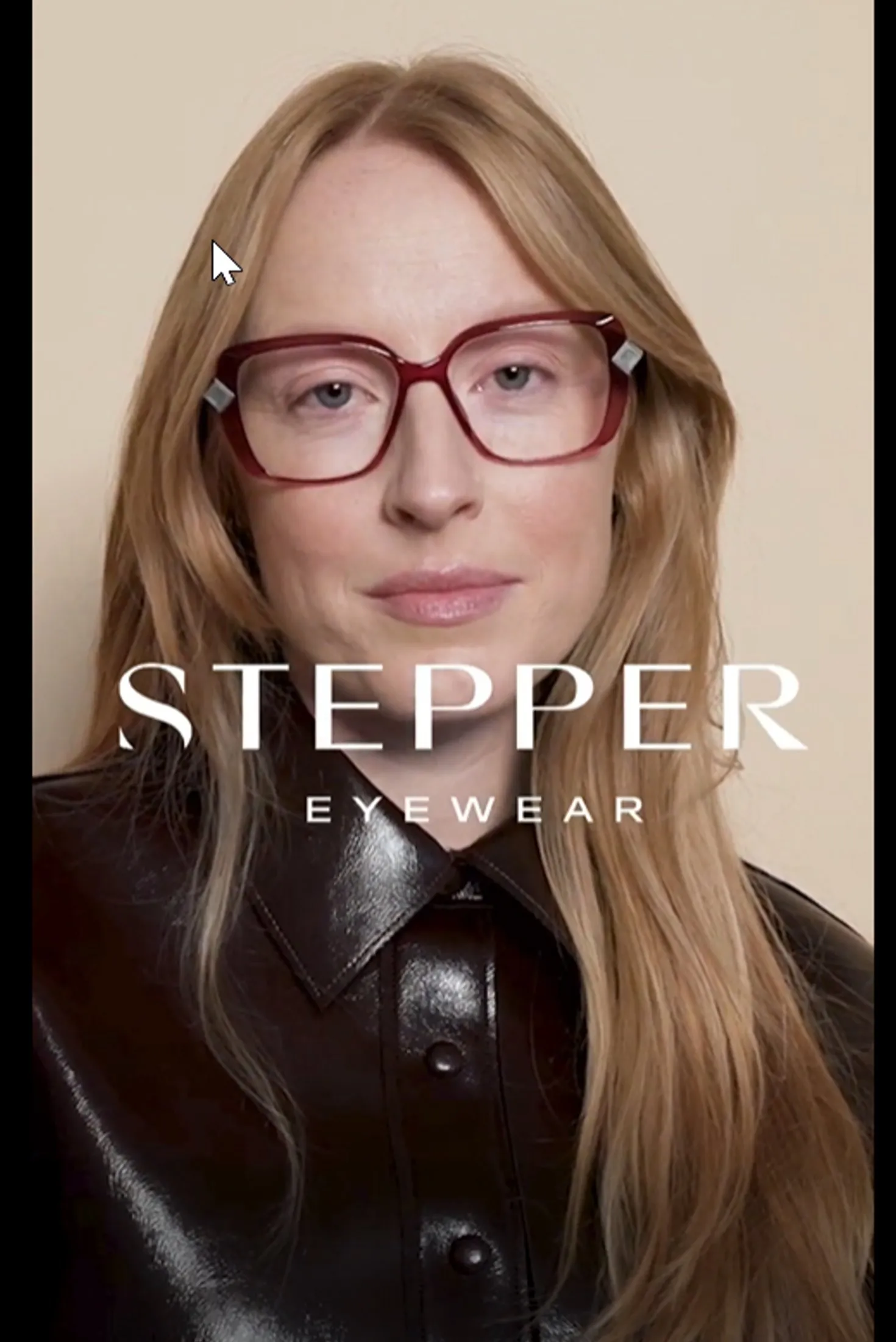 Close-up of a woman with long blonde hair wearing large red-framed glasses and a dark shiny button-up shirt with STEPPE EYEWEAR text overlay.