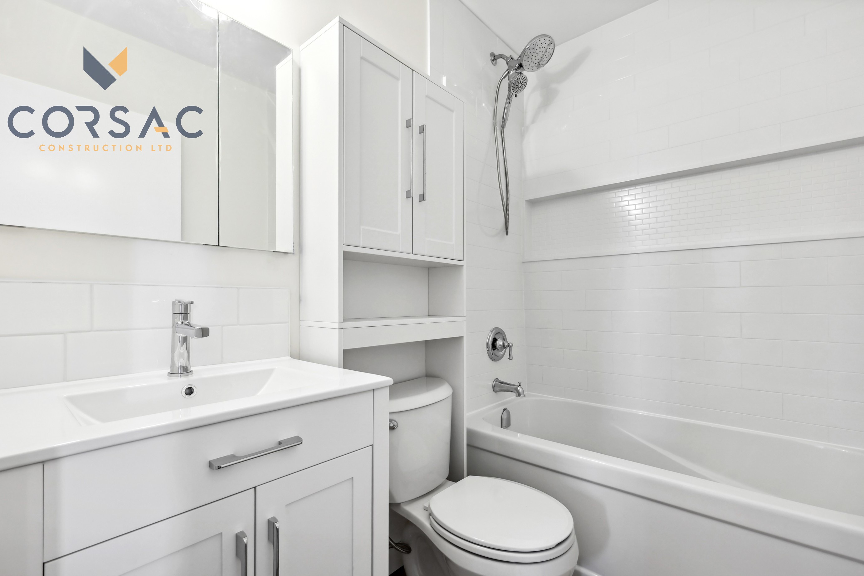 Modern white bathroom with a sink, mirror, toilet, and bathtub with a showerhead.