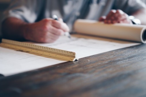 Basement under construction with wooden framing for walls and pink insulation on the exterior walls.