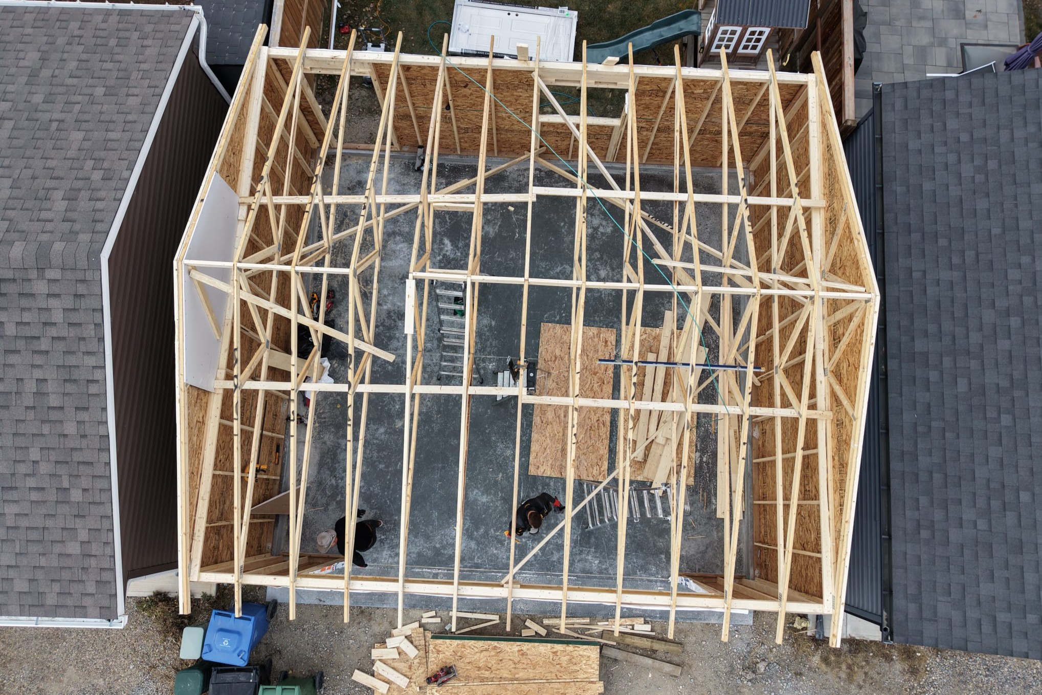 Basement under construction with wooden framing for walls and pink insulation on the exterior walls.