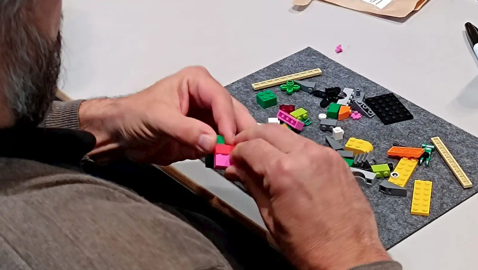 Ein Mann beim Zusammensetzen von Legosteinen