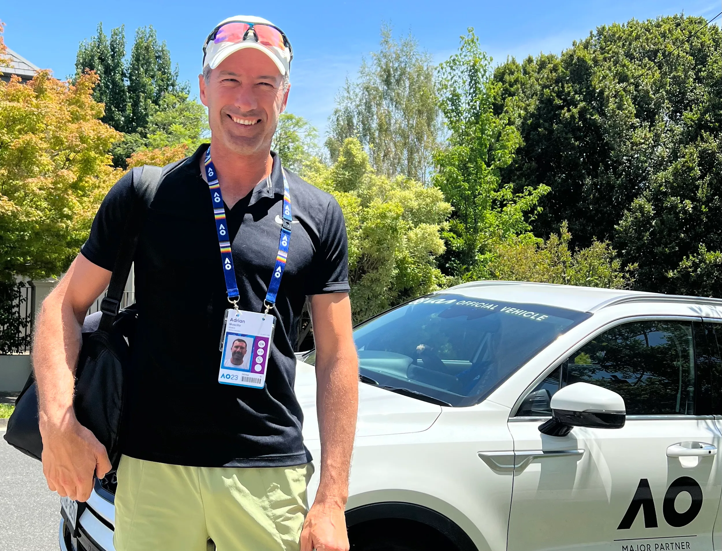 Portrait of Adrien AJ Muscillo standing in a tennis court.