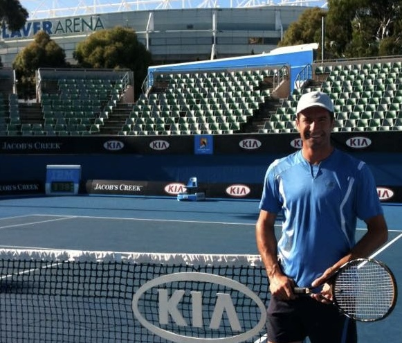 Portrait of Adrien AJ Muscillo standing next to a Australian Open car.