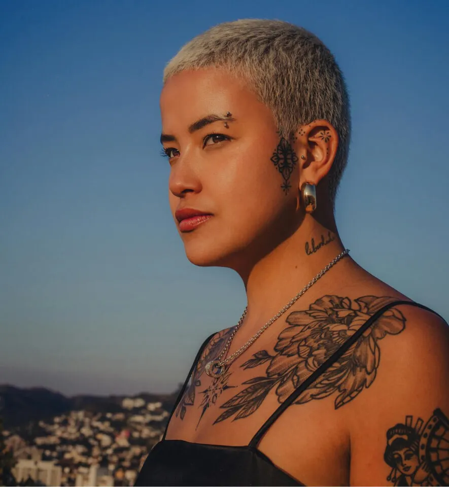 a woman with tattoos on her neck and shoulders