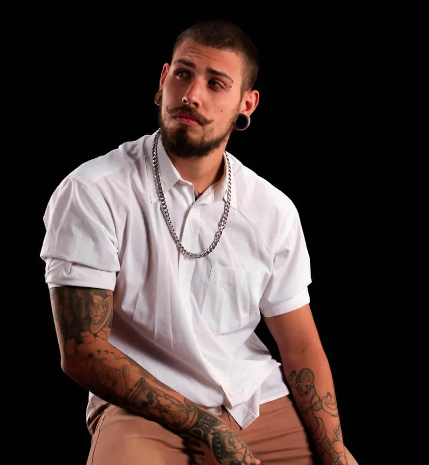 a man with ear tunnels looking a far