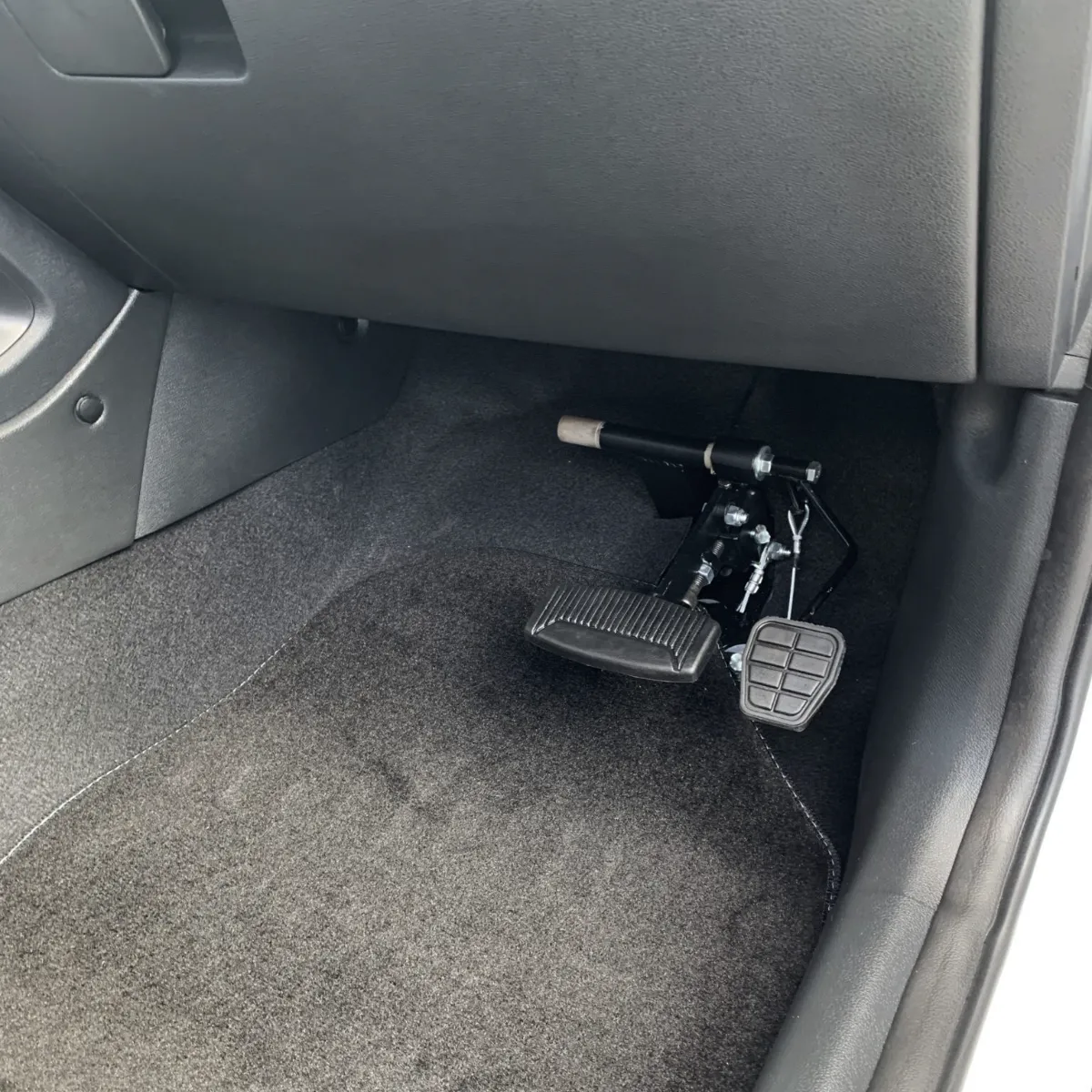 The instructor's brake pedal on the passenger side of LLG's training car