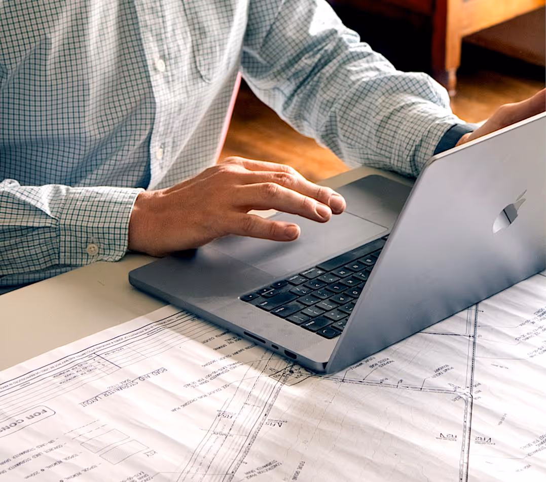 Linerworks employee working at table on laptop